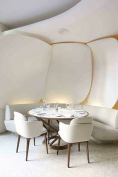 a dining room with round tables and white chairs