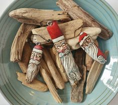 some wooden sticks and ornaments are on a blue plate with a red candle in the middle