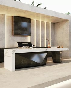 a modern kitchen with marble counter tops and black appliances on the wall, along with an outdoor dining area