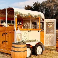 a food truck is decorated with greenery and candles for an outdoor wedding or bridal party