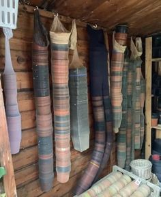 many different colored vases are hanging on the wall in a room with wood paneling