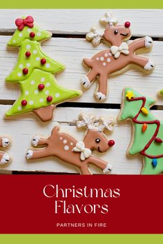 christmas flavored cookies are arranged in the shape of reindeers and trees on a white wooden table