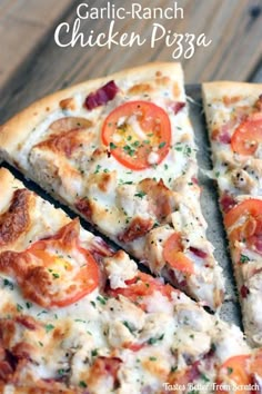 a close up of a pizza on a pan with tomatoes and chicken in the middle