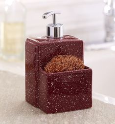 a red soap dispenser sitting on top of a counter