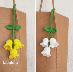 two bags with crocheted flowers attached to them, one in yellow and the other in white