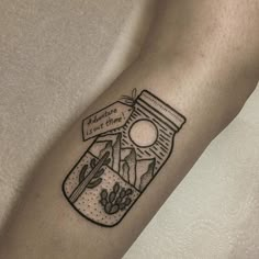 a person with a tattoo on their arm that has a jar and cactus in it