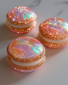 three pink and white marble covered buttons with gold glitter trimmings on each one