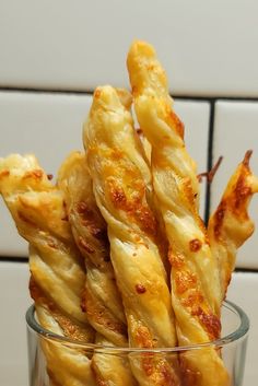 a glass filled with cheesy bread sticks