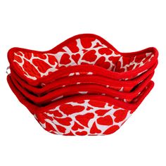 four red and white giraffe print fabric bowls on a white background with clippings