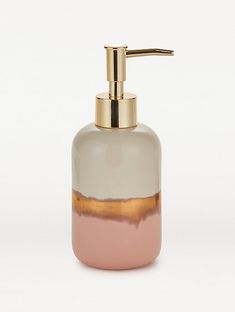 a soap dispenser with a pink and grey liquid in it on a white background