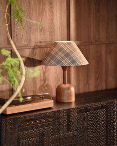 a lamp sitting on top of a wooden dresser