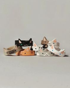 four different types of cat headbands on a white surface with one black, one brown and one green