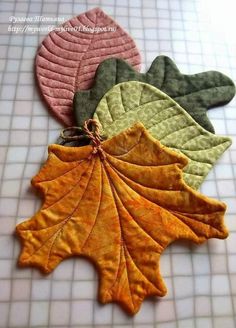 four leaf shaped placemats sitting on top of a tiled floor