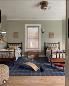 a bedroom with two twin beds and blue carpet