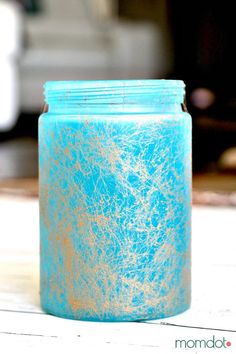 a blue jar sitting on top of a wooden table