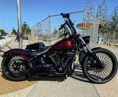 a red and black motorcycle parked on the street