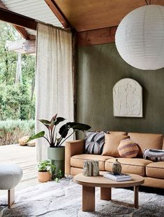 a living room filled with furniture and a large white ball hanging over the top of it