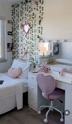 a bedroom with two beds and a desk in front of a window that has ivy growing on the wall