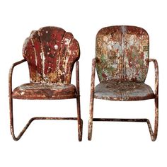 two old chairs sitting next to each other on top of a white surface with peeling paint