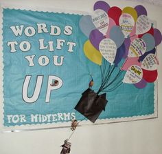 a bulletin board with words to lift you up and balloons in the air above it