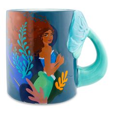 a blue coffee mug with an image of a mermaid on it