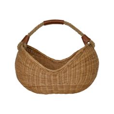 a wicker bag with leather handles on a white background