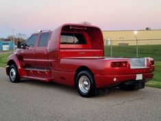 a red truck is parked on the side of the road