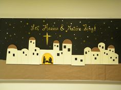 a nativity scene with paper cutouts and gold lettering on black background that says, let heaven & nature sing