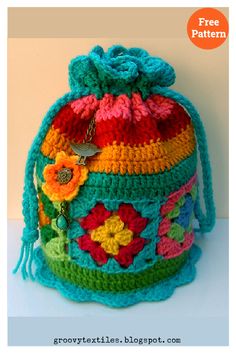 a crocheted bag with flowers and tassels on the front is shown