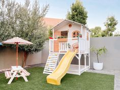 there is a play house with a yellow slide