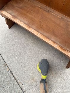 a person standing next to a bench with a shoe on the ground in front of it