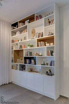 a white book shelf filled with lots of books