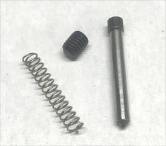 an image of a spring and screw on the ground