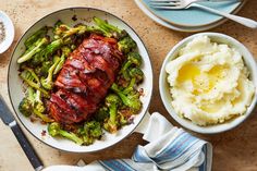 a plate with meat, broccoli and mashed potatoes next to a bowl of mashed potatoes