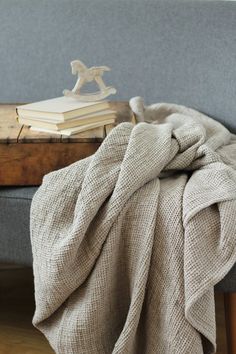 a blanket is draped over a bench with books on it