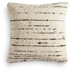 a white and brown pillow with black lines on the front, sitting on a white surface