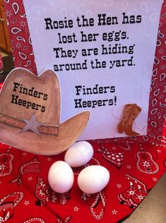 some eggs and a cowboy hat sitting on a table with a sign that says, rose the hen has lost her eggs they are hiding around the yard finders