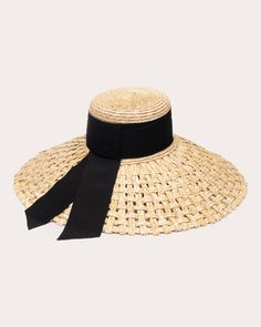 Designed with a flat top, the Mirabel sun hat is created from basket-woven straw and detailed with a grosgrain band and tails. The wide, downward-slanted brim offers shade on high UV days. Grosgrain band and tails Inner adjustable band Basket weave 100% straw Spot clean Made in China Measurements Grosgrain band width: 3in Brim: 6.5in Sustainability Metrics: Circular Economy: product is intentionally designed with 50% of actively cycled materials Clean ingredients: 100% of materials used are natu Eugenia Kim Hat, Pearl Clutch, Bad Haircut, Heritage Crafts, Straw Sun Hat, Straw Basket, Wide Brim Sun Hat, Vintage Ribbon, Eugenia Kim