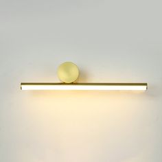 a wall mounted light on the side of a white wall