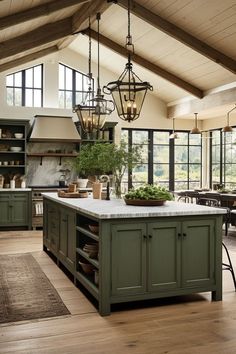 a large kitchen with an island in the middle and lots of windows on both sides