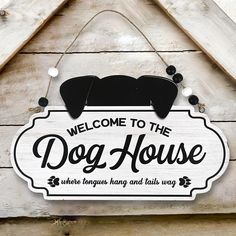 a wooden sign that says welcome to the dog house, where tongues hang and tail is way