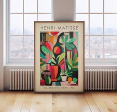 there is a poster on the floor in front of a window that reads henry matisse