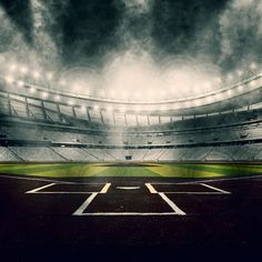 an empty baseball stadium filled with lots of dark clouds and light from the lights on the stands