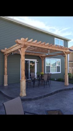 a patio with chairs and an attached pergolan