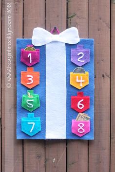 a colorful piece of paper with numbers on it and a bow tie hanging from the side