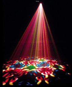 the light is shining brightly in the dark with colorful circles around it and on the ground