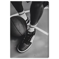 black and white photograph of a basketball player's feet with his shoes on the court