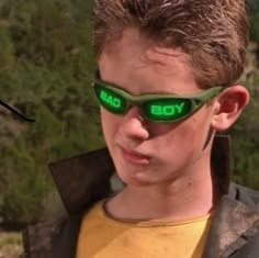 a young man wearing sunglasses with the word yo on it's side and green tinted lens