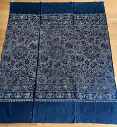 three pieces of blue cloth on a wooden floor