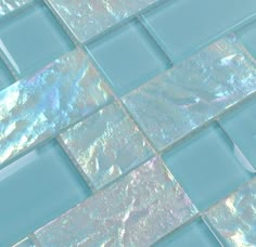 a close up view of a blue glass tile with iridescents on it